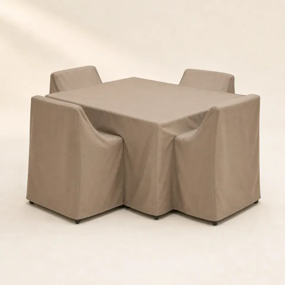 Fitted taupe Cove weather cover protecting a compact patio dining set